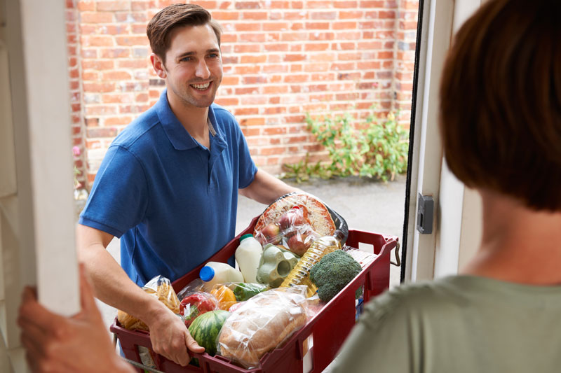 Picture of Groceries with a man delivering